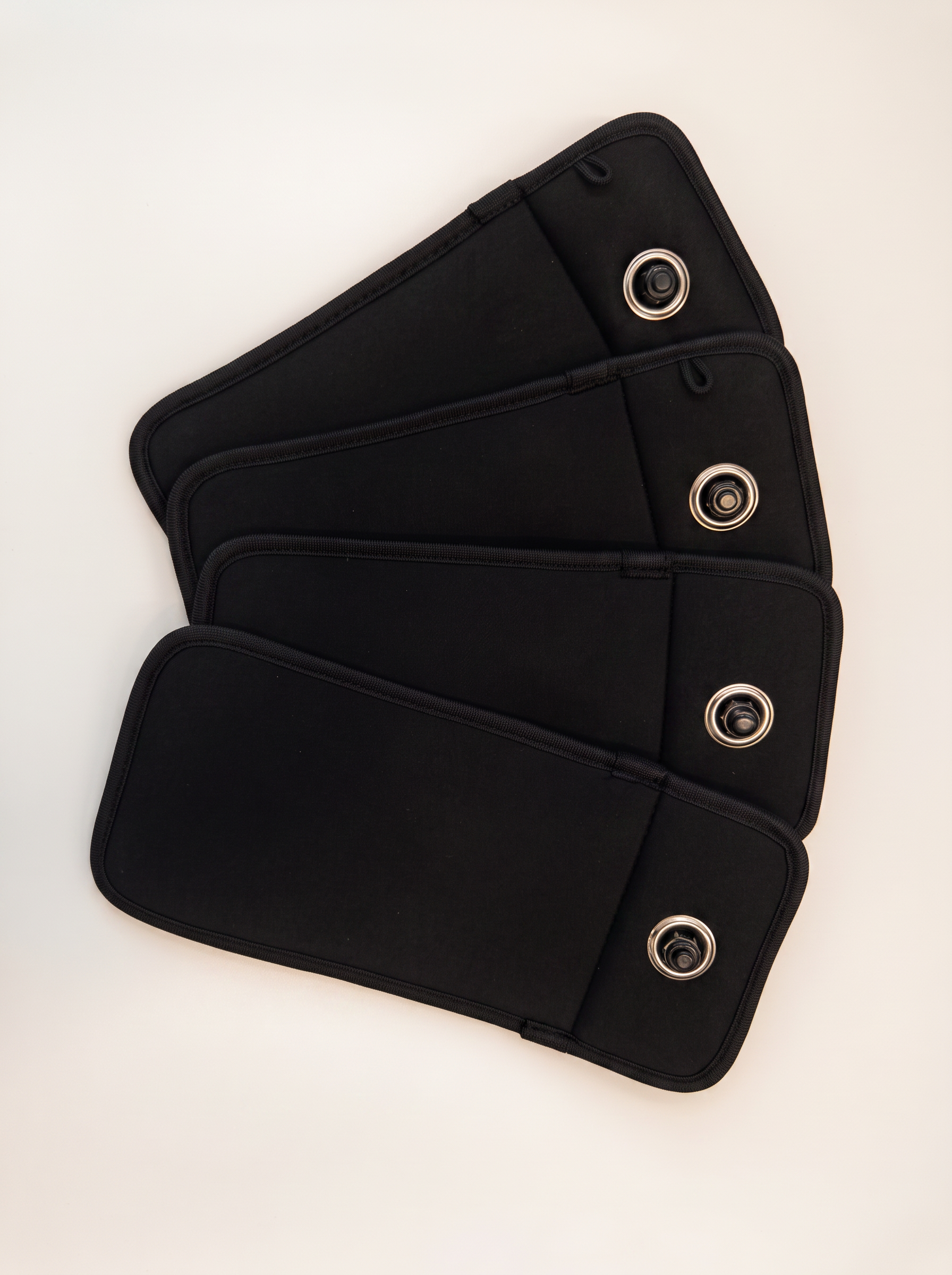 Four closed TOVI pouches laid out in a row.